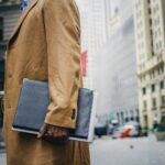 black man with folder in overcoat